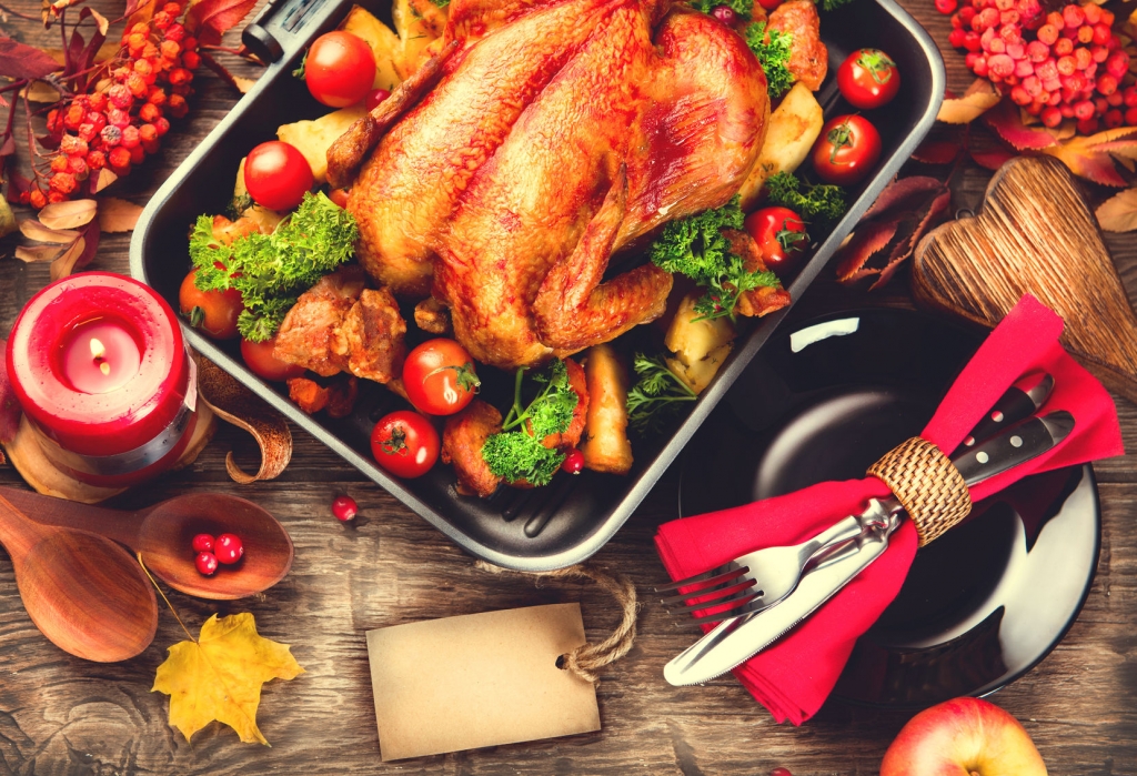 48215802 - thanksgiving dinner table served with turkey, decorated with bright autumn leaves